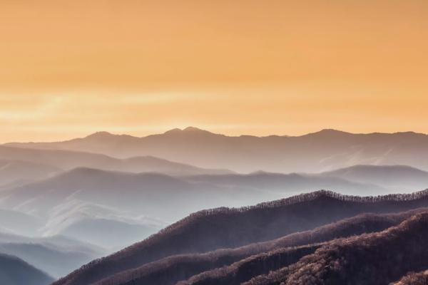 first rays of the sun falling on the smoky mountains