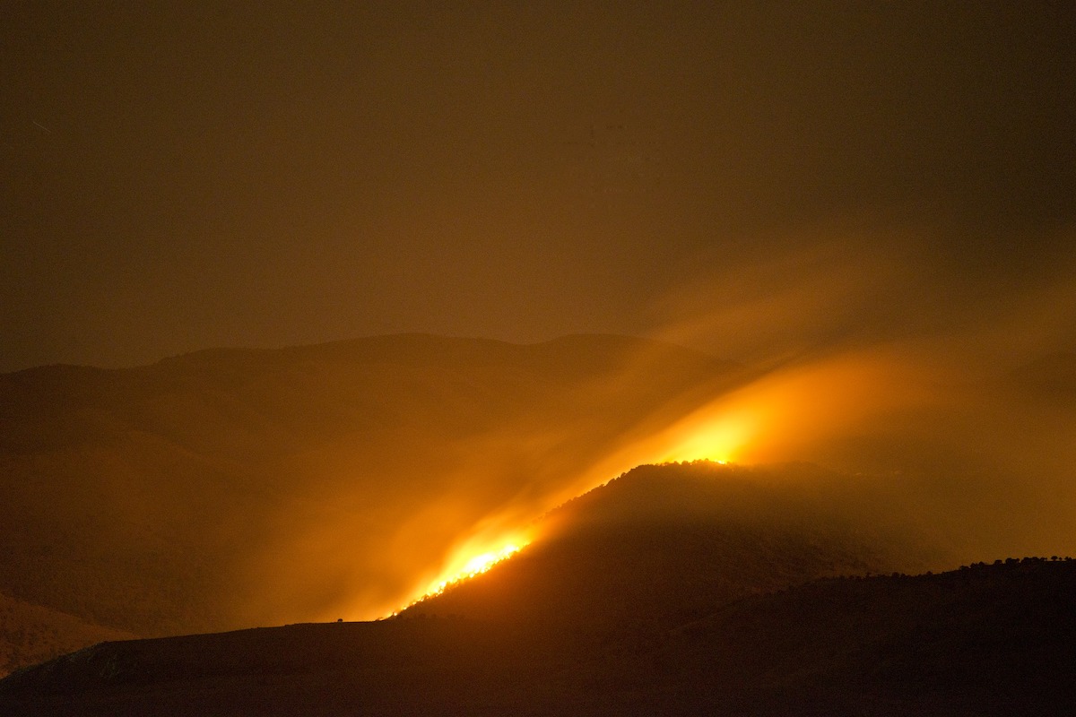 night picture of fire glowing on mountainside